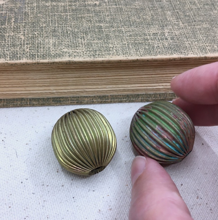 Brass ridged bead on left. Same bead on right with rustic patina in blue, green and metal colors. 