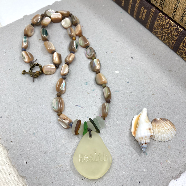 Necklace with cultured sea glass and shell beads. 