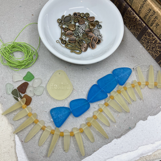 Beading materials including metal components, various shapes of cultures sea glass and stringing cord. 