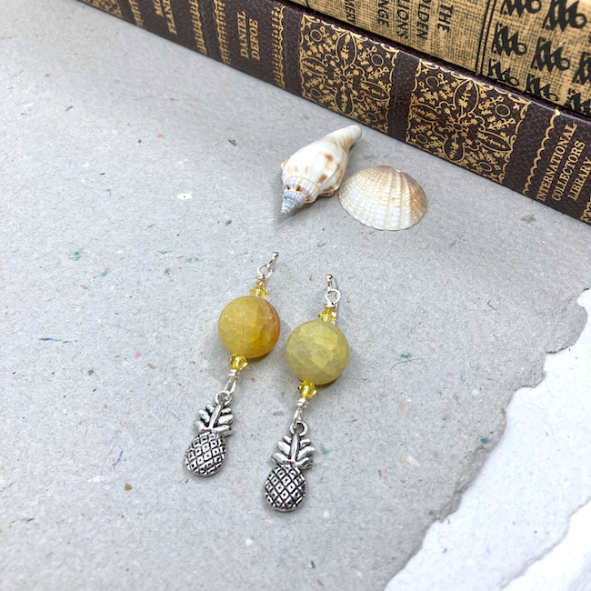 Earrings with yellow agate and crystal with silver pineapple charms. 