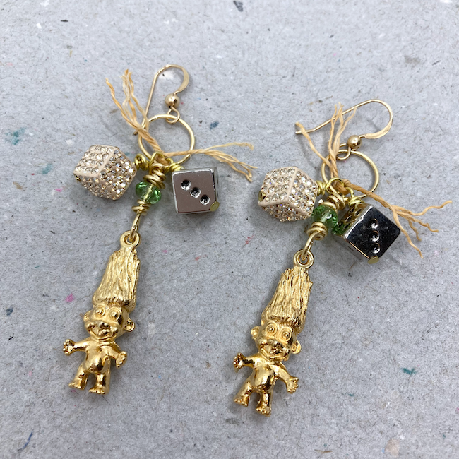 Earrings with gold troll doll charms and dice beads. 